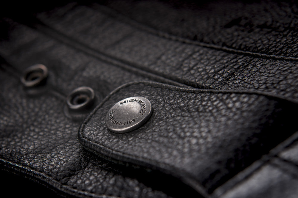 Primer jacket in black showcasing button clasp