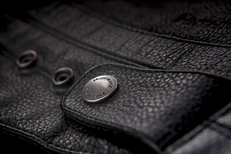Primer jacket in black showcasing button clasp